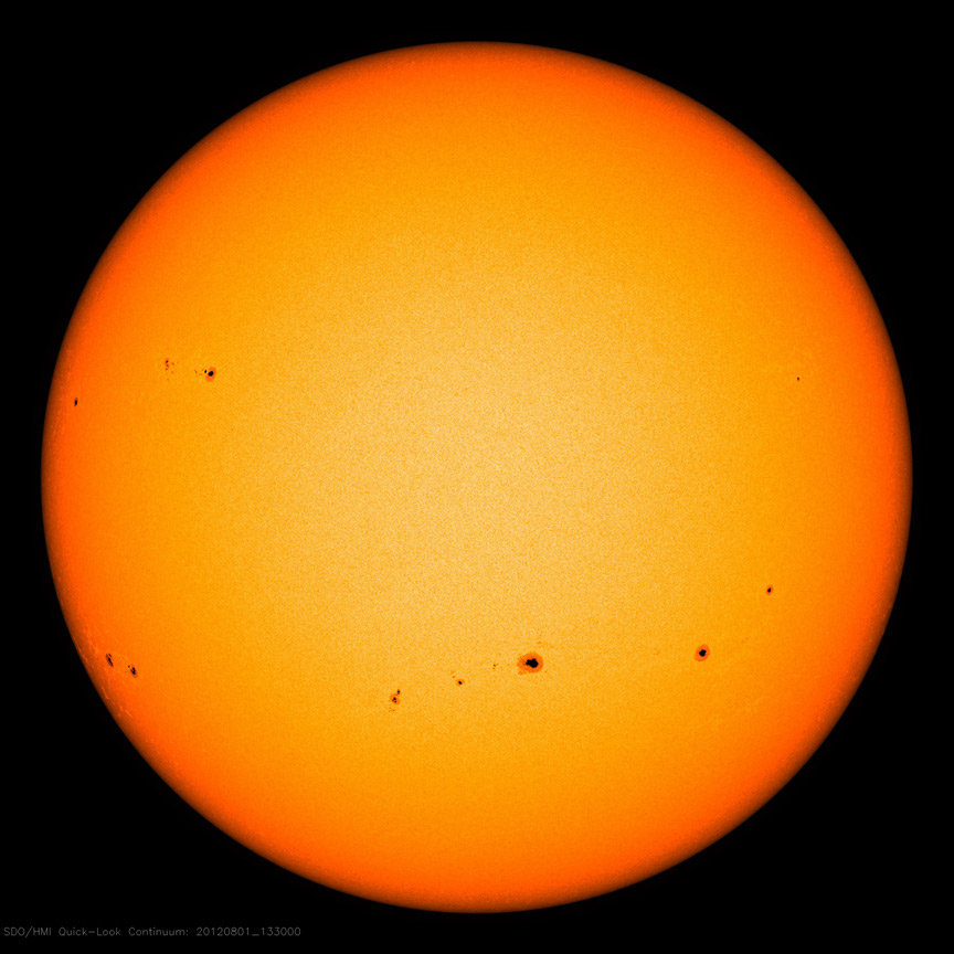 Image showing groups of sunspots as dark patches which lie in bands above and below the Sun's equator
