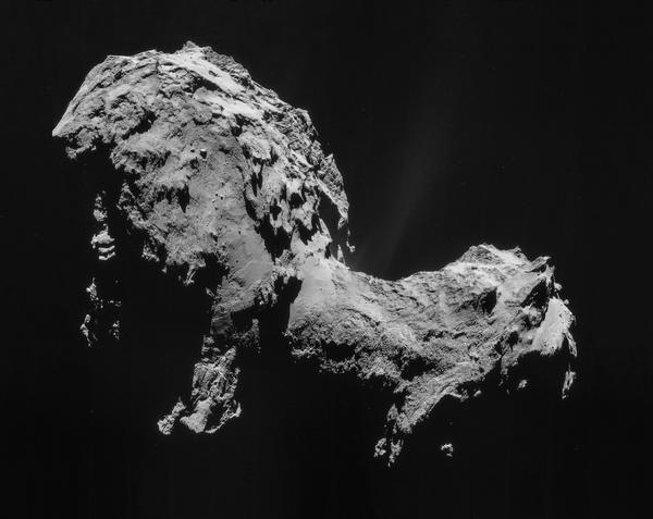 This comet nucleus looks like two large, bumpy lumps joined together. A small jet of material is being blown off the nucleus
