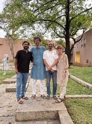 Four people standing in a courtyard