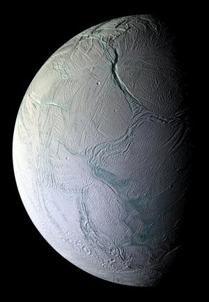 A partially illuminated Enceladus. The smooth surface is covered by many  straight and curved crevices