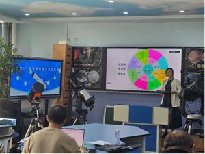 A woman gives a talk in a classroom which several telescopes