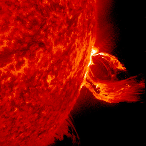 Two bright arcs of material, two halves of a broken loop, project outwards from a section of the Sun.