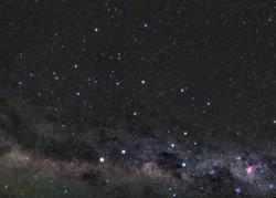 The Southern Cross forms a kite shape in front of the mottled light and dark patches of the Milky Way.