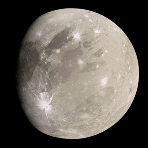 Close-up image of Ganymede, Jupiter's largest moon, showcasing its cratered, icy surface with prominent ridges and grooves.