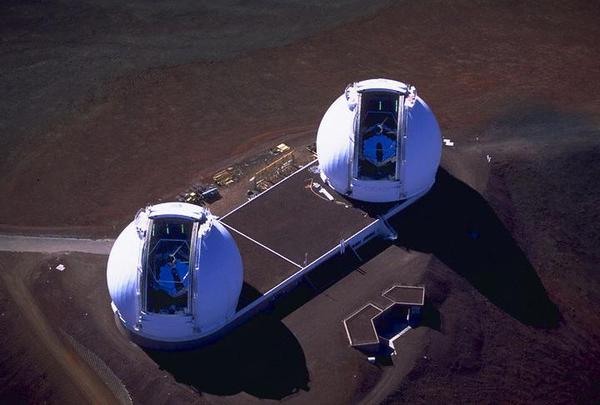 The two Keck telescopes seen from above. The domes are open and the telescopes' mirrors can be seen inside.