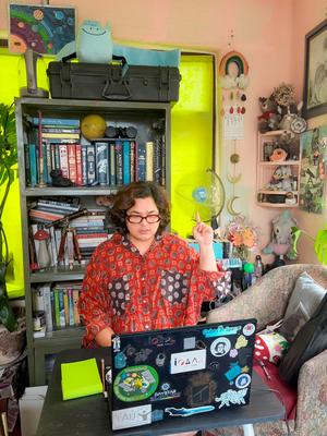 Manisha Dwa sitting in-front of a laptop.