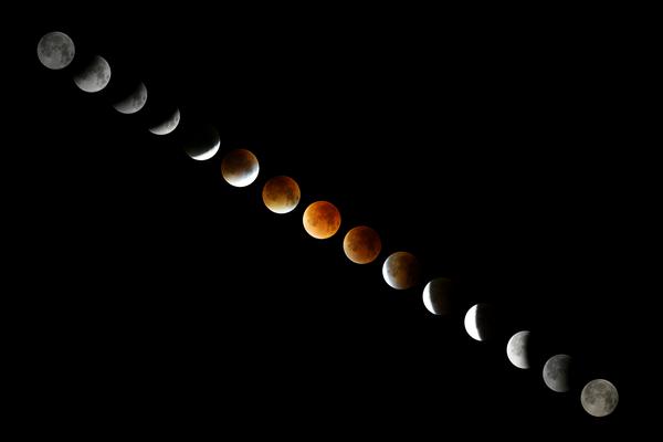 A composite of images of the Moon. Along the sequence of images, the Moon's colour changes from grey to red and back to grey.