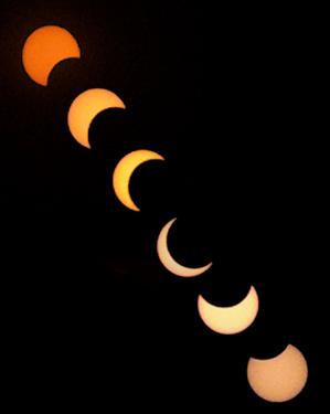 Six images of the Sun. The moon moves across the Sun’s disk, covering most in the middle images before moving away.